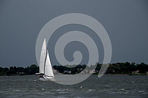 White Sails against Dark Stormy Sky