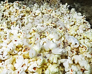 White salted pop corn heaped for sale. close up view