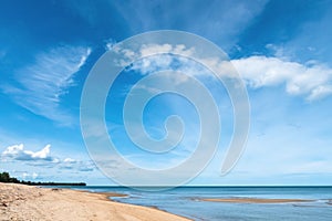 White sand beach with clear wave water over blue sky with white clouds a beautiful scene in nature