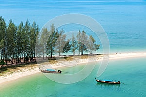 White sand beach and Long-tail boat at Kham-Tok Island koh-kam-tok, The beautiful sea Ranong Province, Thailand