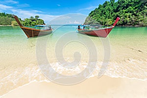 White sand beach and Long-tail boat at Kham-Tok Island koh-kam-tok, The beautiful sea Ranong Province, Thailand