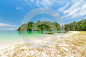 White sand beach and Long-tail boat at Kham-Tok Island koh-kam-tok, The beautiful sea Ranong Province, Thailand