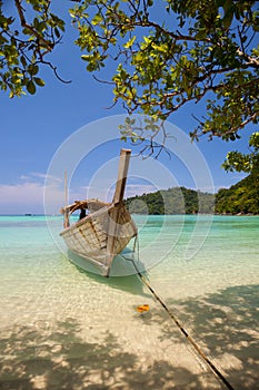 White sand beach with longboat at ocean in Tropicana country under clear sky