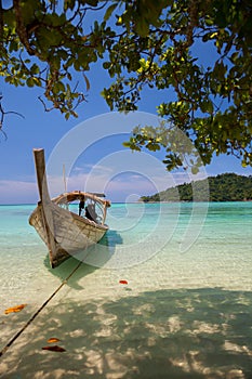 White sand beach with longboat at ocean in Tropicana country under clear sky