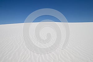 White sand dune and blue sky