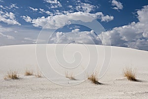 White sand dune and clouds