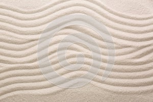 White sand with pattern as background, top view. Concept of zen and harmony