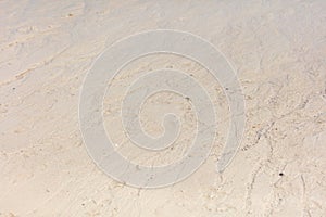 White sand on the seashore as an abstract background. Texture