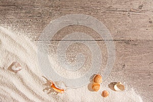 White sand and and shells on planked wood. Summer background with copy space. Top view