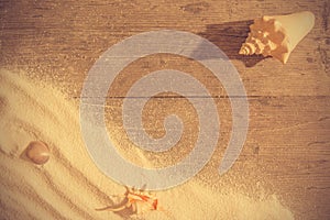 White sand and and shels on planked wood. Summer background with copy space. Top view