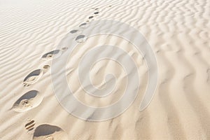 white sand texture with footprints in the dunes