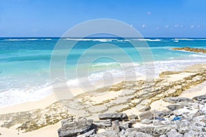 White sand, turquoise waters against the blue sky at Pandawa Beach, Bali, Indonesia.