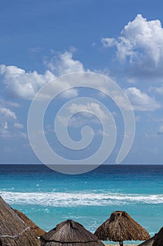 White sandy beach in the Caribbean with rows of huts