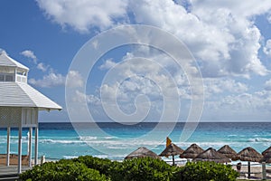 White sandy beach in the Caribbean with rows of huts