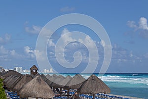White sandy beach in the Caribbean with rows of huts