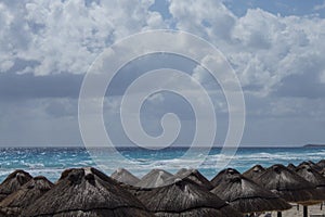 White sandy beach in the Caribbean with rows of huts