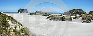 White sandy beach panorama with rocks