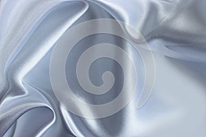 White satin background. Silk fabric with pleats. Satin, silk or satin create a beautiful drapery.