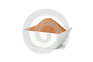 White sauceboat with cinnamon powder isolated