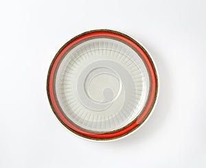 White saucer with red rim