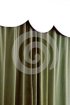 White scalloped wood valance with green velvet curtains