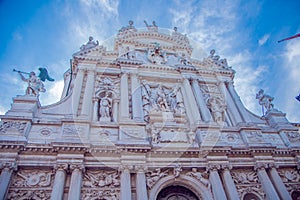 White Scalzi Cathedral in Venice with columns and statues of saints