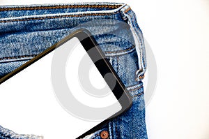 White screen smartphone in jeans pocket. Smartphone place for text. Smartphone in a pocket on a white background.  Copy Space