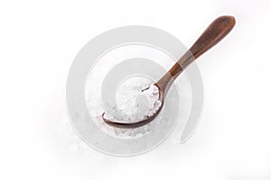 White sea bath salt in a wooden spoon