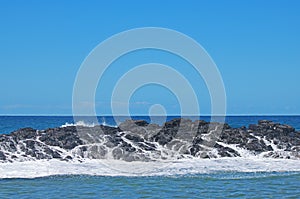 ROCKS WITH SEA WATER AND FOAM RUNNING OFF