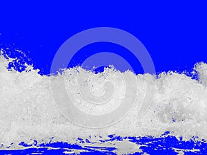 White sea foam from the surf, isolated on a bright royal blue background