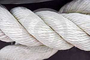 White sea rope close-up on a wharf in the summer