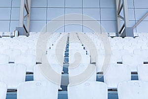 white seats in the stadium. Child looks into the distance