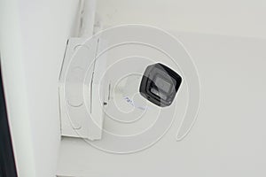 White security camera install on a white wall