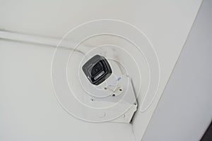 White security camera install on a white wall