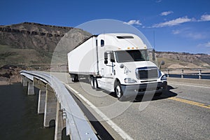 White Semi driving the bridge