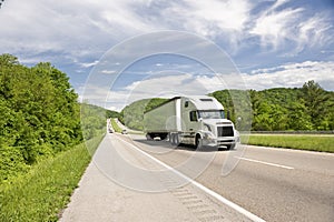 White Semi Truck On Highway In Springtime