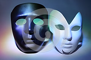 White serious and black masks (man and woman)