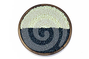 White sesame and black sesame seed on wooden coasters for background.