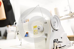 White sewing machine on the table in the workshop