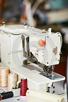 White sewing machine with threads nearby