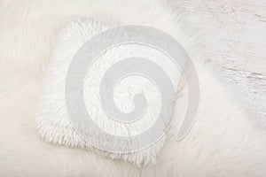 White shaggy carpet and cozy pillow background. Home interior background