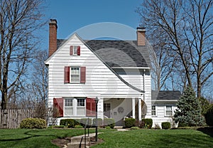 White Shake House with Peaked Roof & Red Shutters