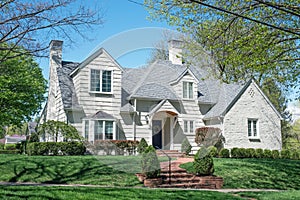 White Shake and Stone House with Curving Brick Walk