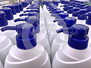 White Shampoo Bottles with Blue Dispensing Caps