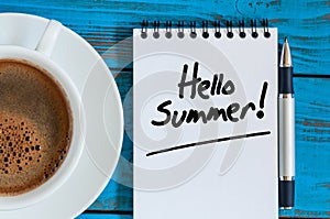 White sheet of notepad with Hello summer text and morning coffee mug