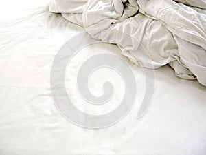 White sheets and blankets after use, Wrinkled and disorganized.