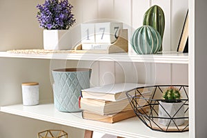 White shelving unit with books and decorative stuff