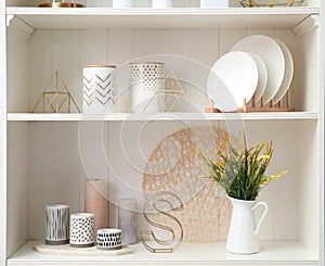 White shelving unit with dishes and decorative stuff
