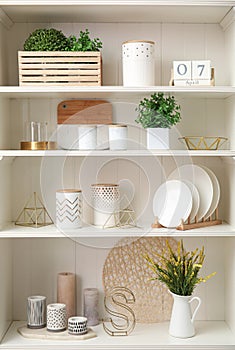 White shelving unit with dishes and decorative stuff