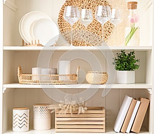 White shelving unit with dishware and decorative stuff